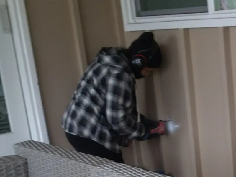 Professional electrician installing an exterior outlet in Lincoln